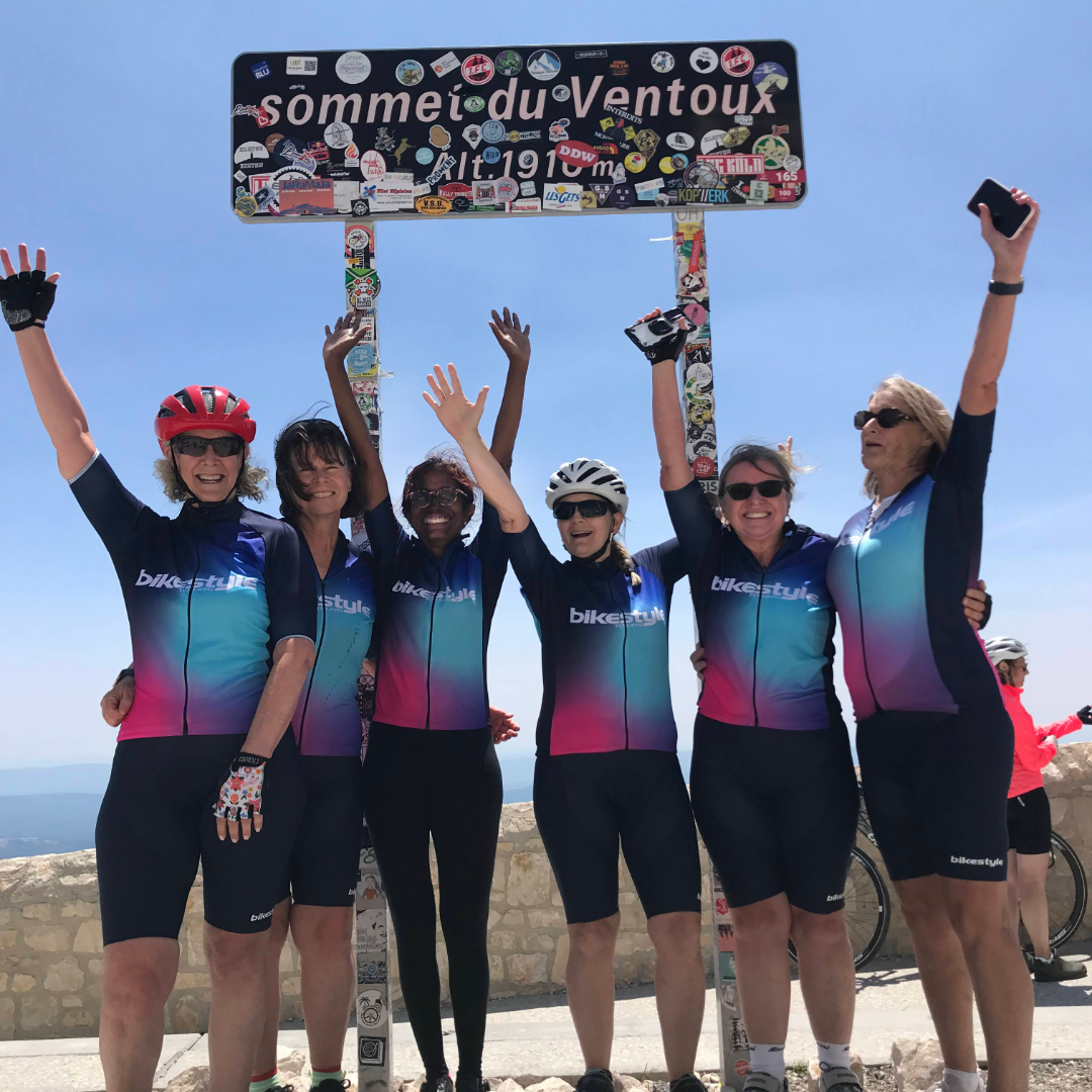 Cyclists in front of the 'Sommet du Ventoux' sign